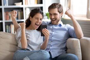 happy couple paying off debt after selling structured settlement for lump sum.