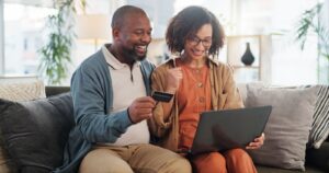 happy couple finding effective strategies for paying your credit card debt.